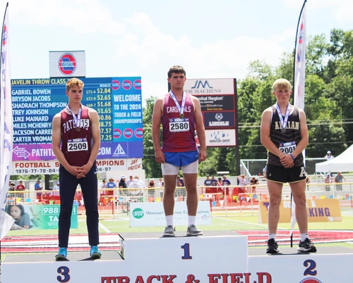 Boy standing on podium.